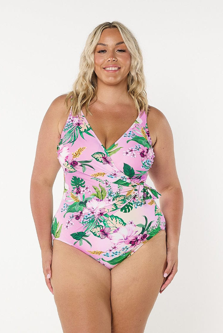Model in studio wearing waist tie one piece in pink floral print