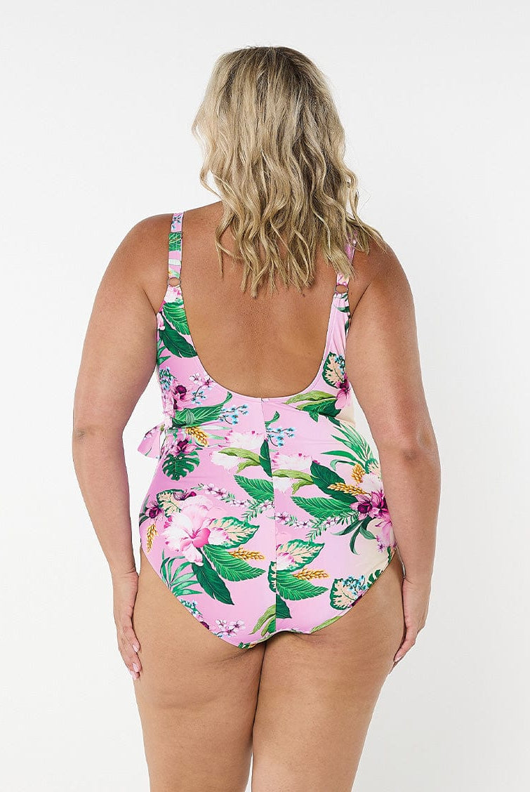 Blonde model facing back in studio wearing multicoloured floral one piece with scoop back and adjsutable straps