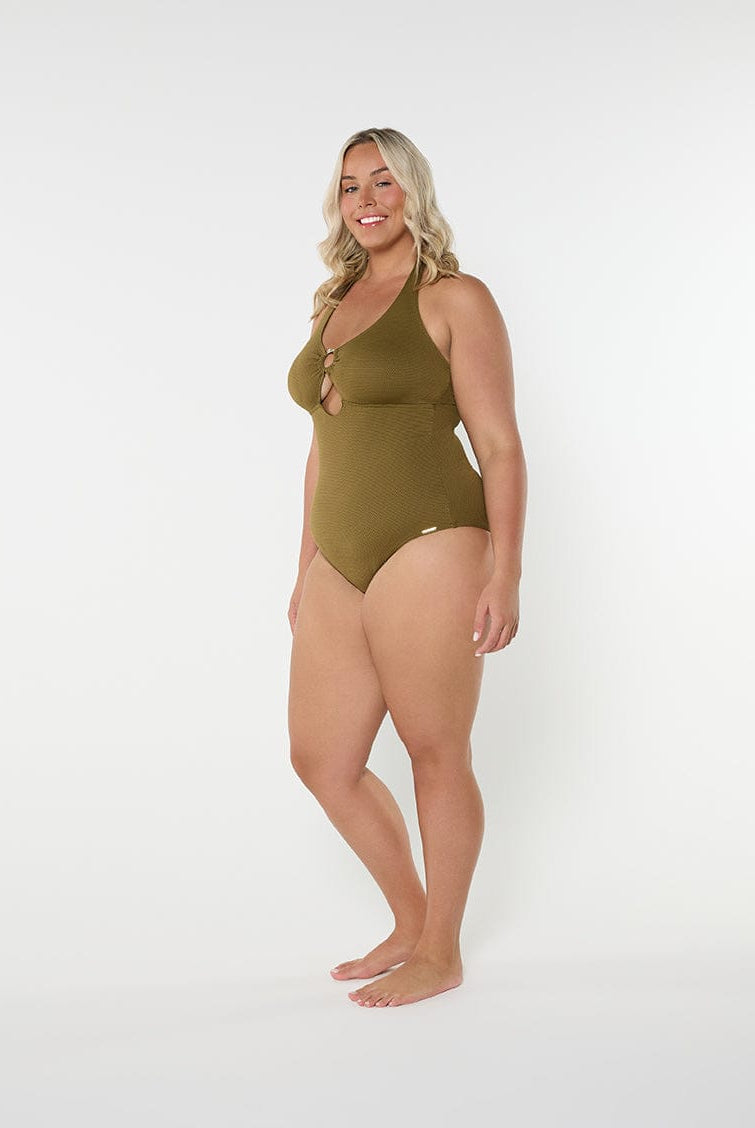Woman wearing a green swimsuit on a white background