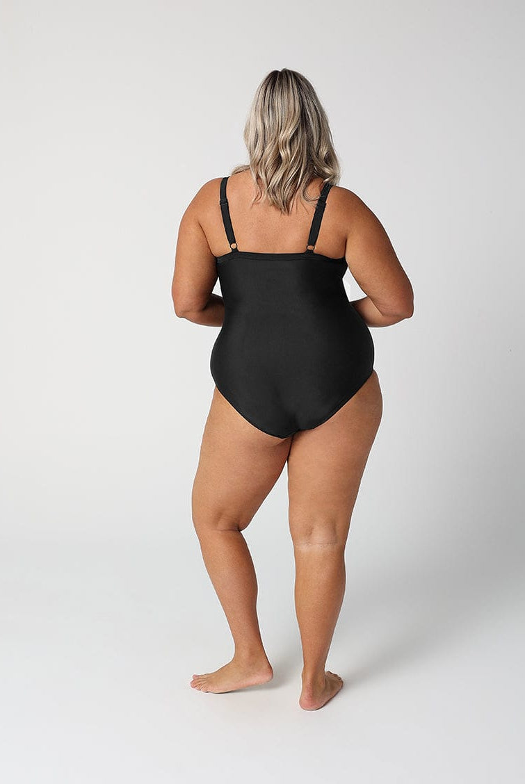 Person wearing a black swimsuit on a white background