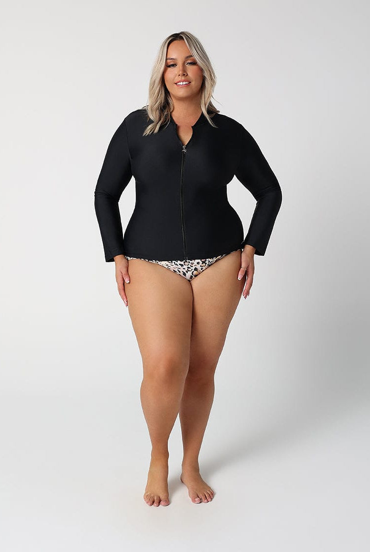 Woman wearing a black wetsuit on a white background