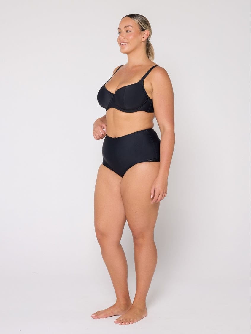 Woman wearing a black bikini on a white background