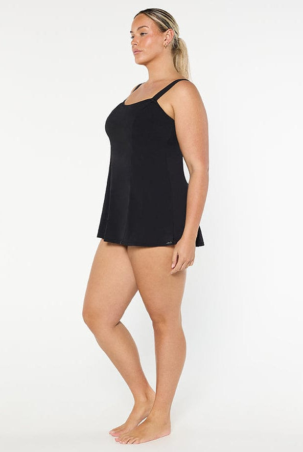 Woman wearing a black slip against a white background