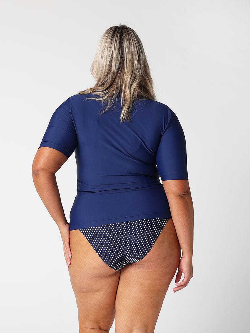 Blonde model showing back of navy short sleeve rash vest