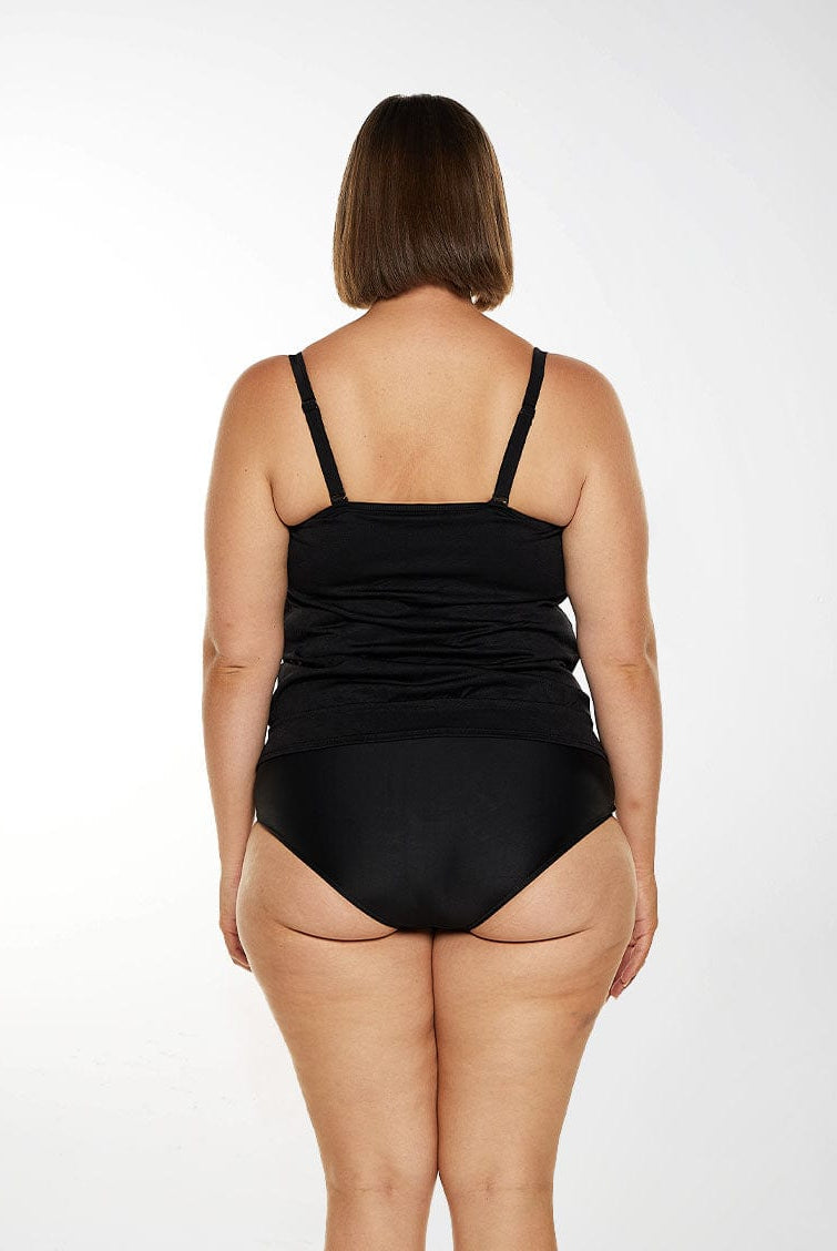 Brunette model wears black tankini top with adjustable and removable straps