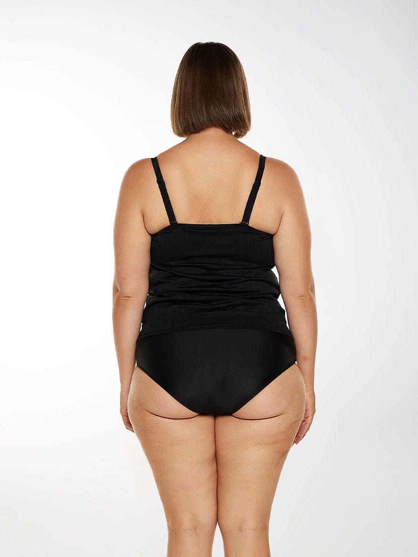 Brunette model wears black tankini top with adjustable and removable straps