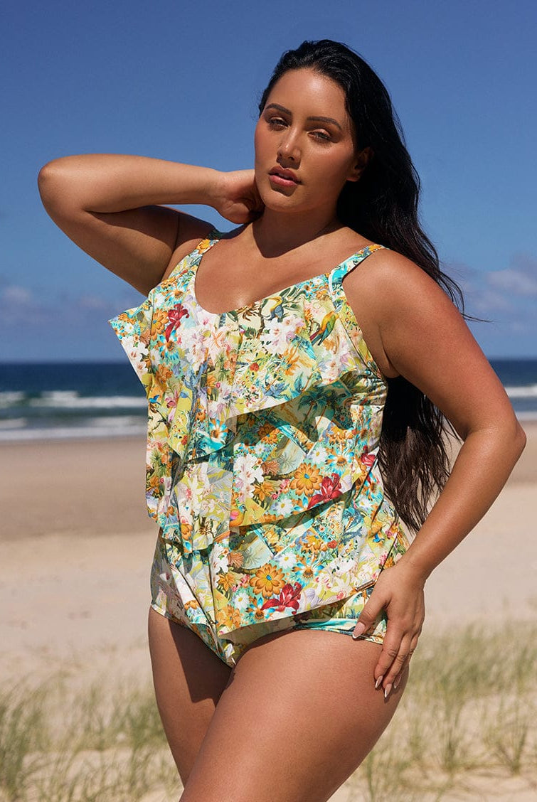 Woman wearing a floral swimsuit on a beach