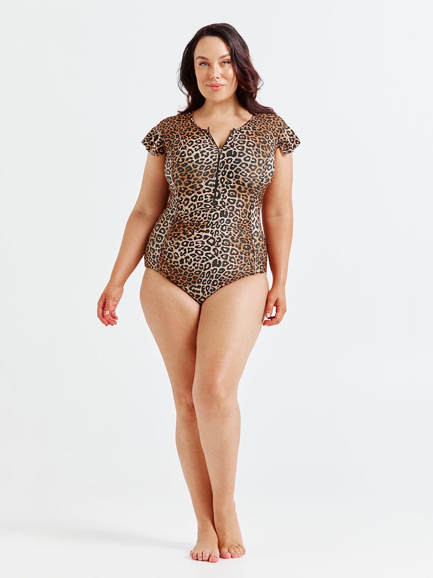Woman wearing a leopard print swimsuit on a white background