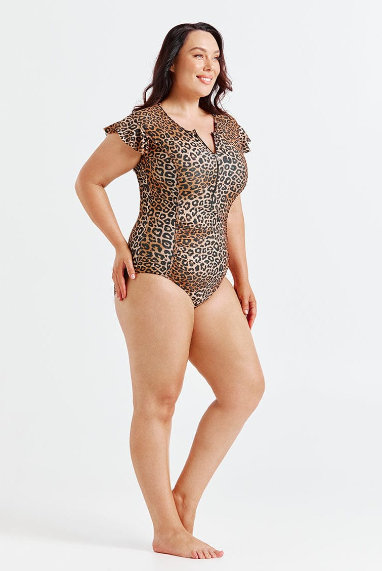 Woman wearing a leopard print swimsuit on a white background