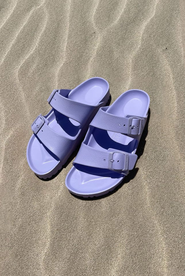 Light purple womens slide on sandals on the beach