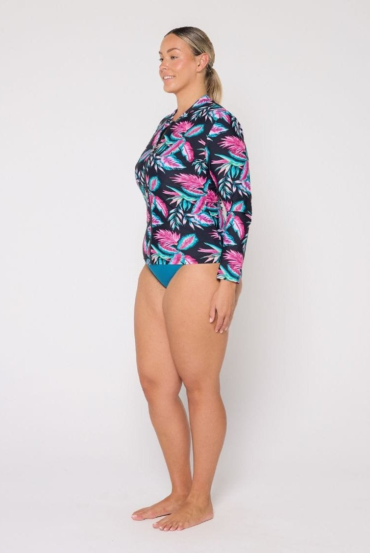 Woman wearing a colorful floral swimsuit on a white background