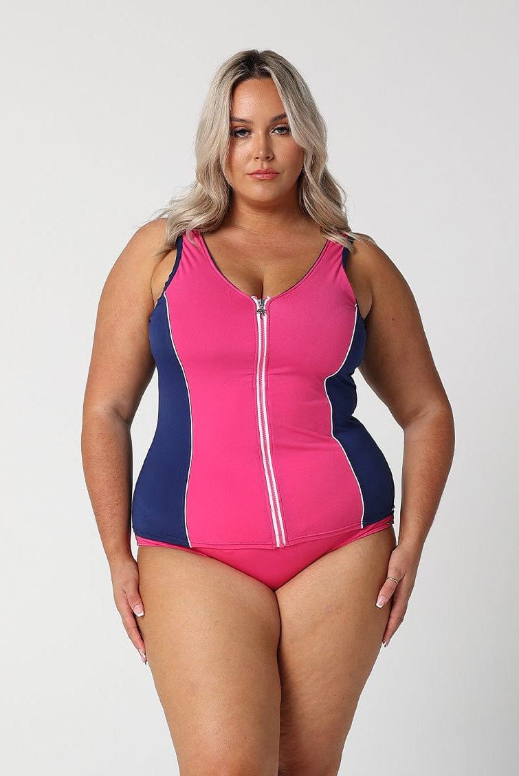 Model wearing pink and navy zip front tankini top