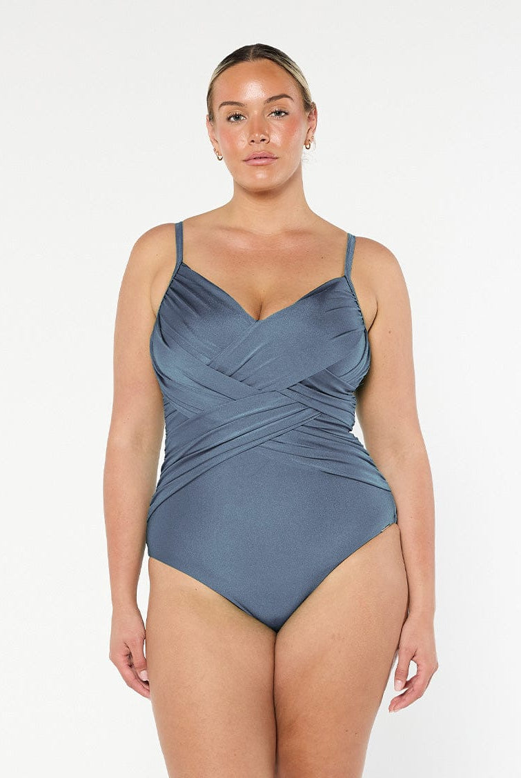 model wearing metallic grey criss cross one piece