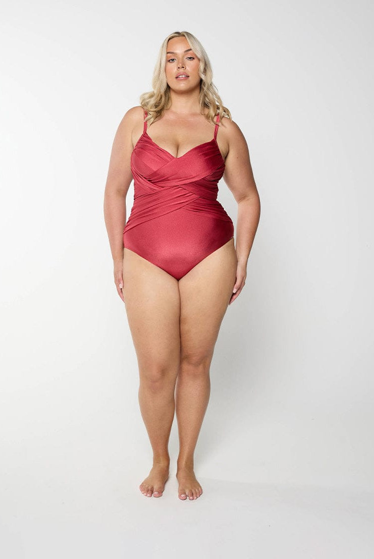 Woman wearing a metallic sangria swimsuit against a white background