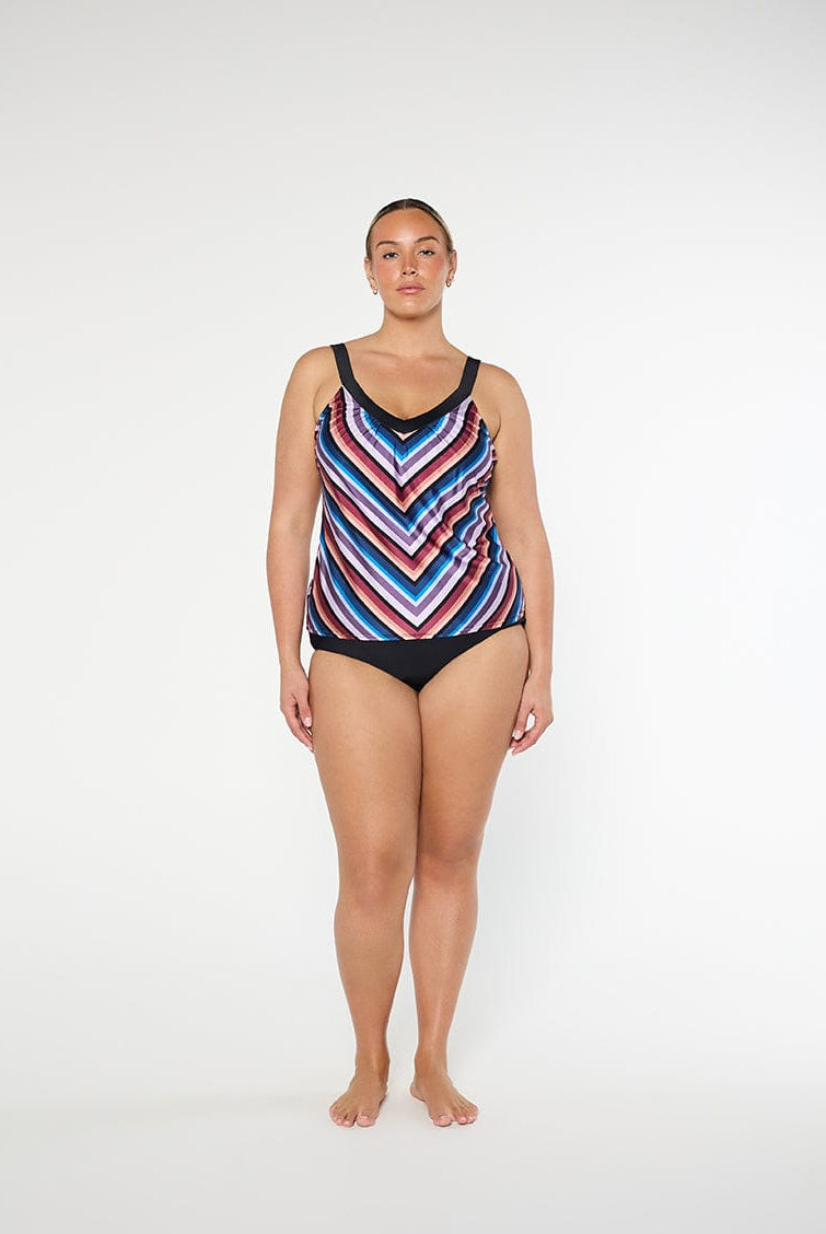 Woman wearing a colorful striped swimsuit on a white background