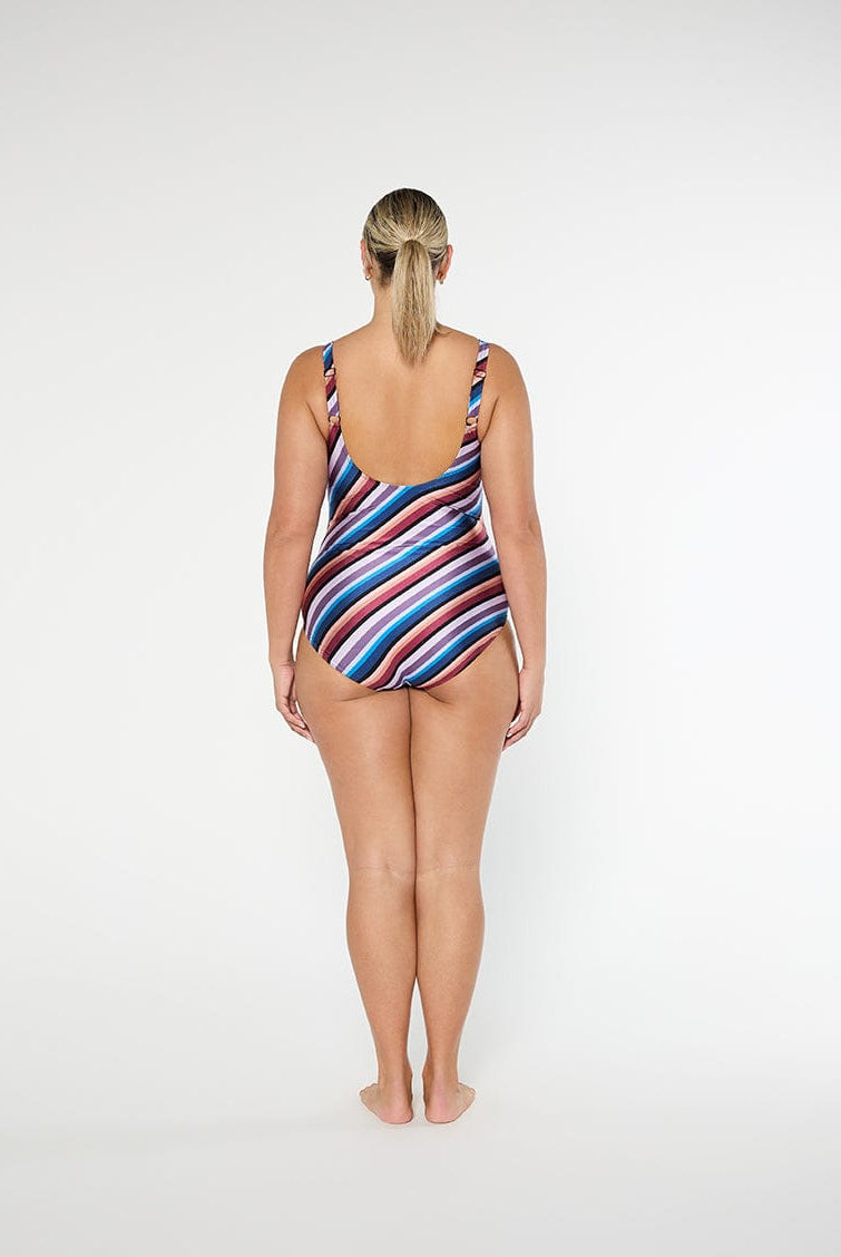 Woman wearing a striped swimsuit on a white background