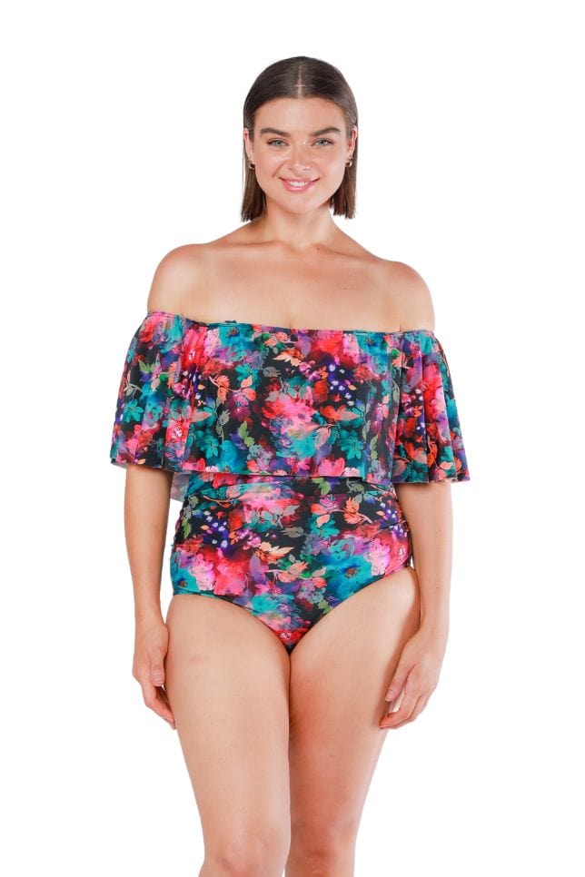Front shot of model wearing off shoulder strapless one piece in pink and blue floral print