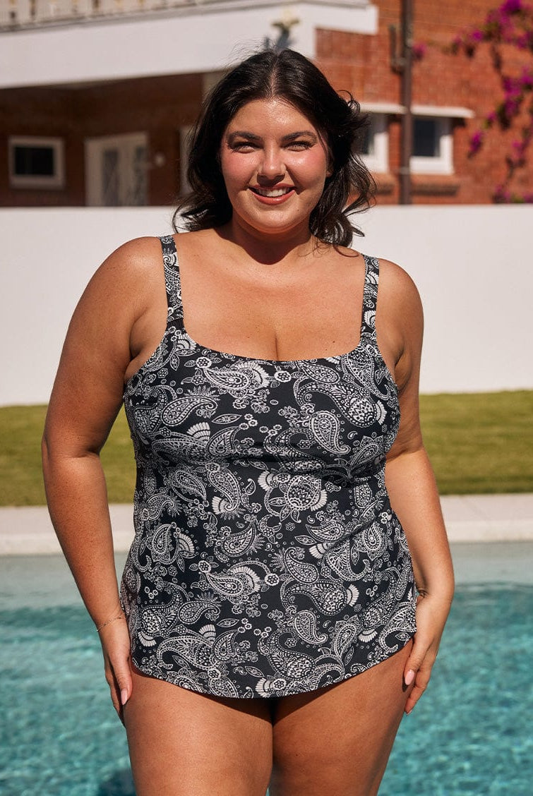 Brunette model by pool wearing flattering tank tankini top in chlorine resistant