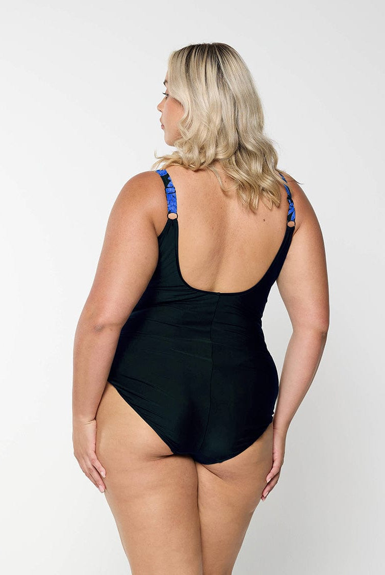 model showing back of blue and black floral women's swimsuit