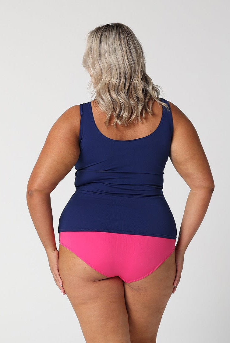 Back of model in studio wearing pink and navy tankini top with full zip in chlorine resistant