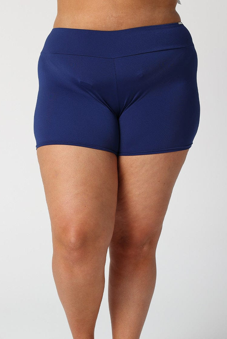 Model showing back of navy boyleg swim bottoms