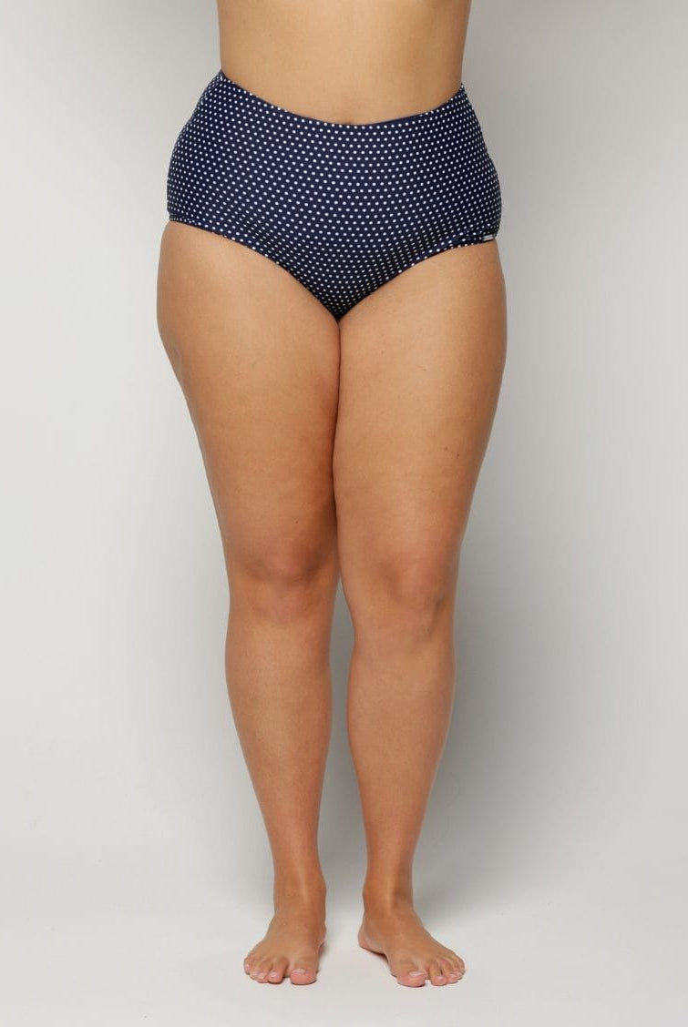 Navy blue polka dot high-waisted bikini bottom on a plain background