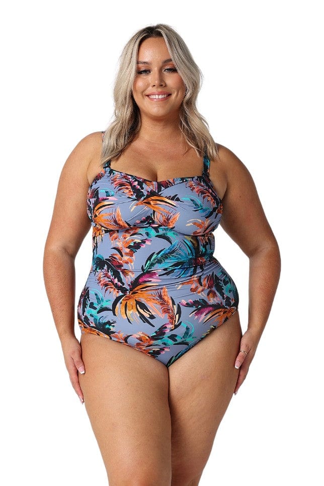 Model wearing tropical print bandeau one piece