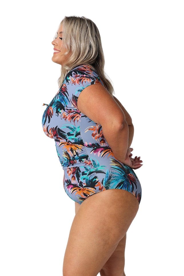 Model showing side of tropical print womens one piece