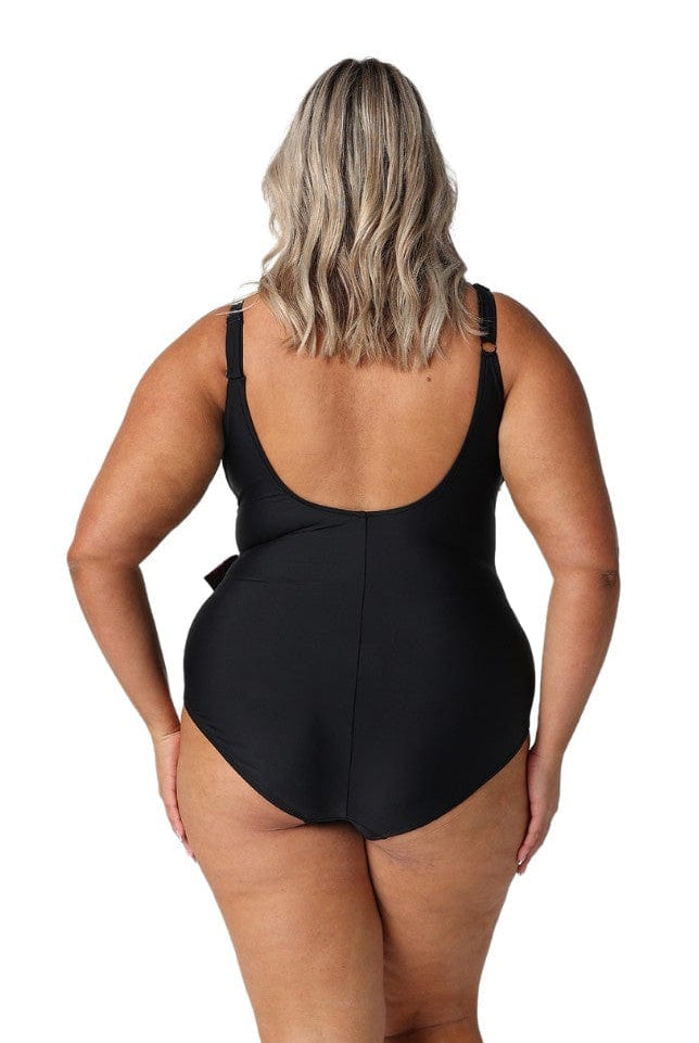 Model showing back of pink and black low back womens one piece