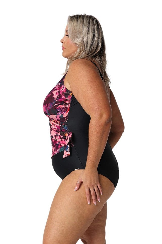 Model showing side of pink and black floral crossover one piece