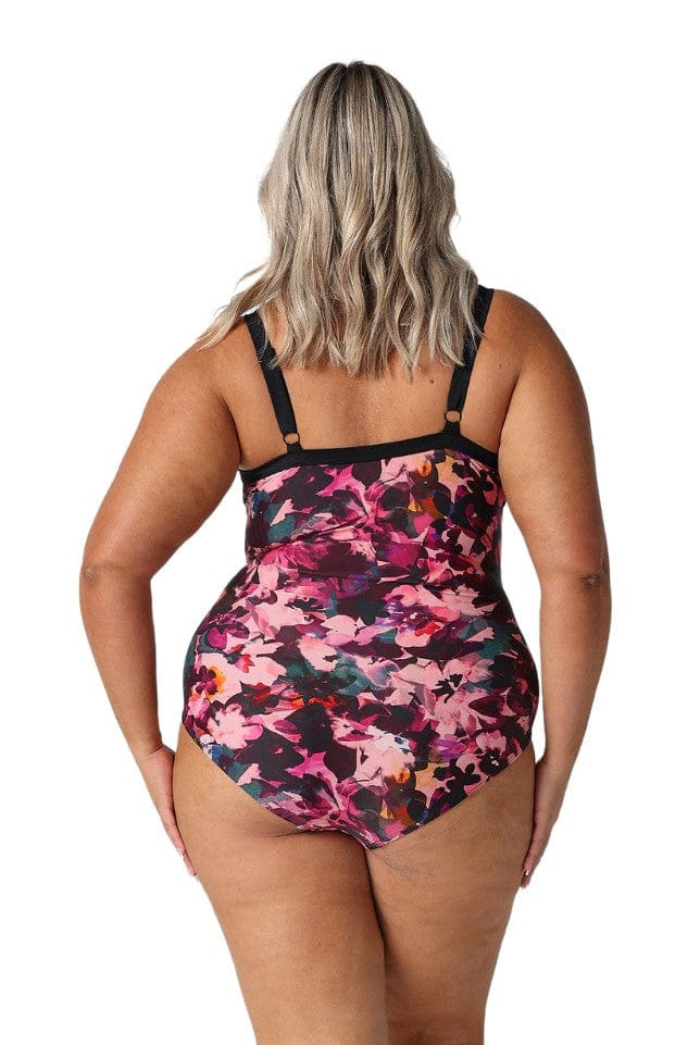 Model showing back of pink and plum one piece swimsuit