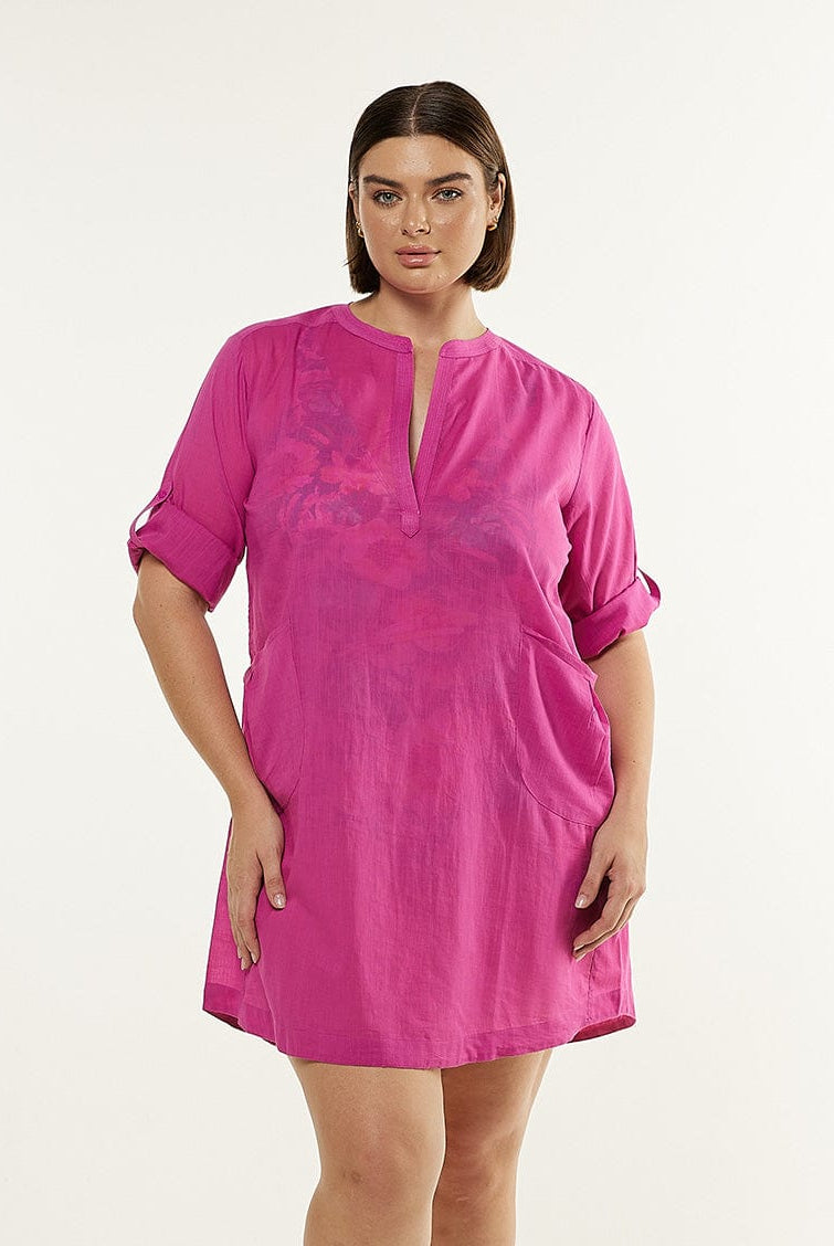 Brunette model wearing pink shirt dress
