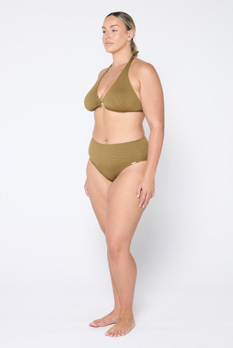 Woman wearing a green bikini set on a white background