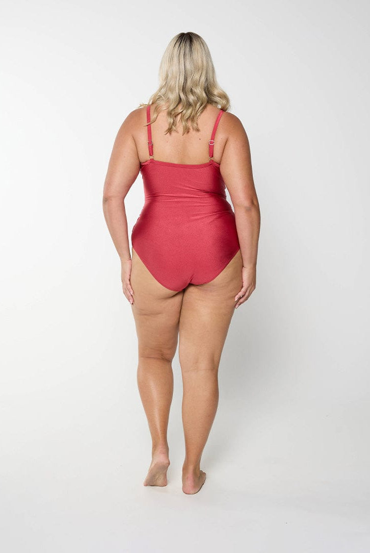 Blonde model in metallic sangria colour swimsuit with stomach ruching