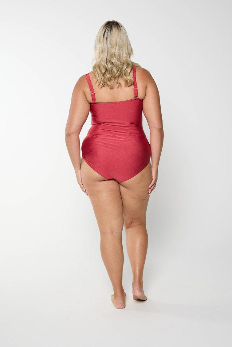 Back of model in studio wearing a bandeau one piece in metallic with adjustable and removable straps