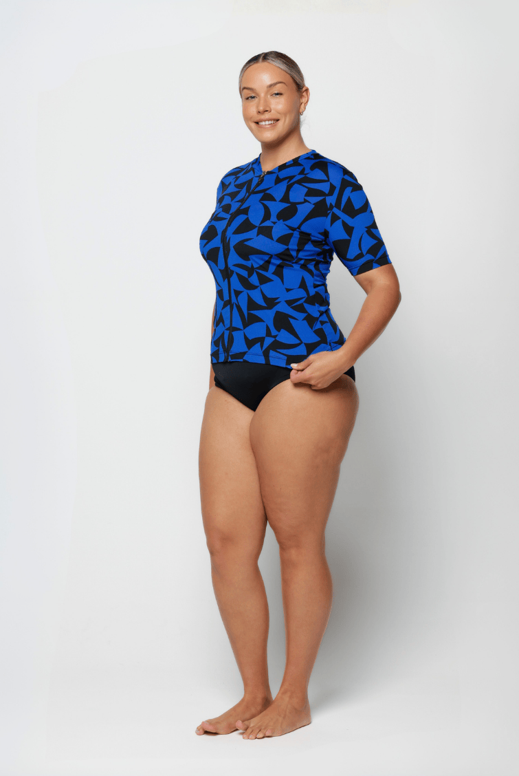 Woman wearing a blue and black patterned swimsuit on a white background