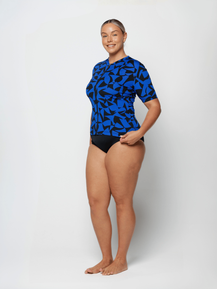 Woman wearing a blue and black patterned swimsuit on a white background