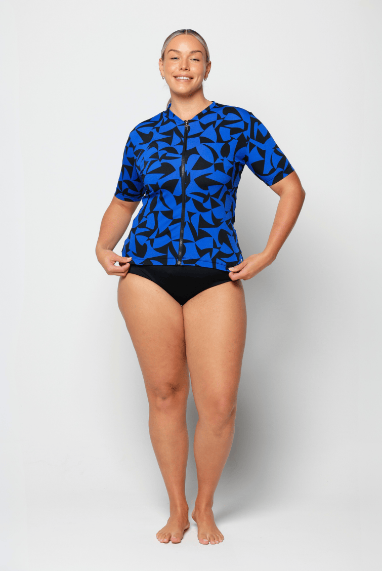 Woman wearing a blue and black patterned swimsuit on a white background