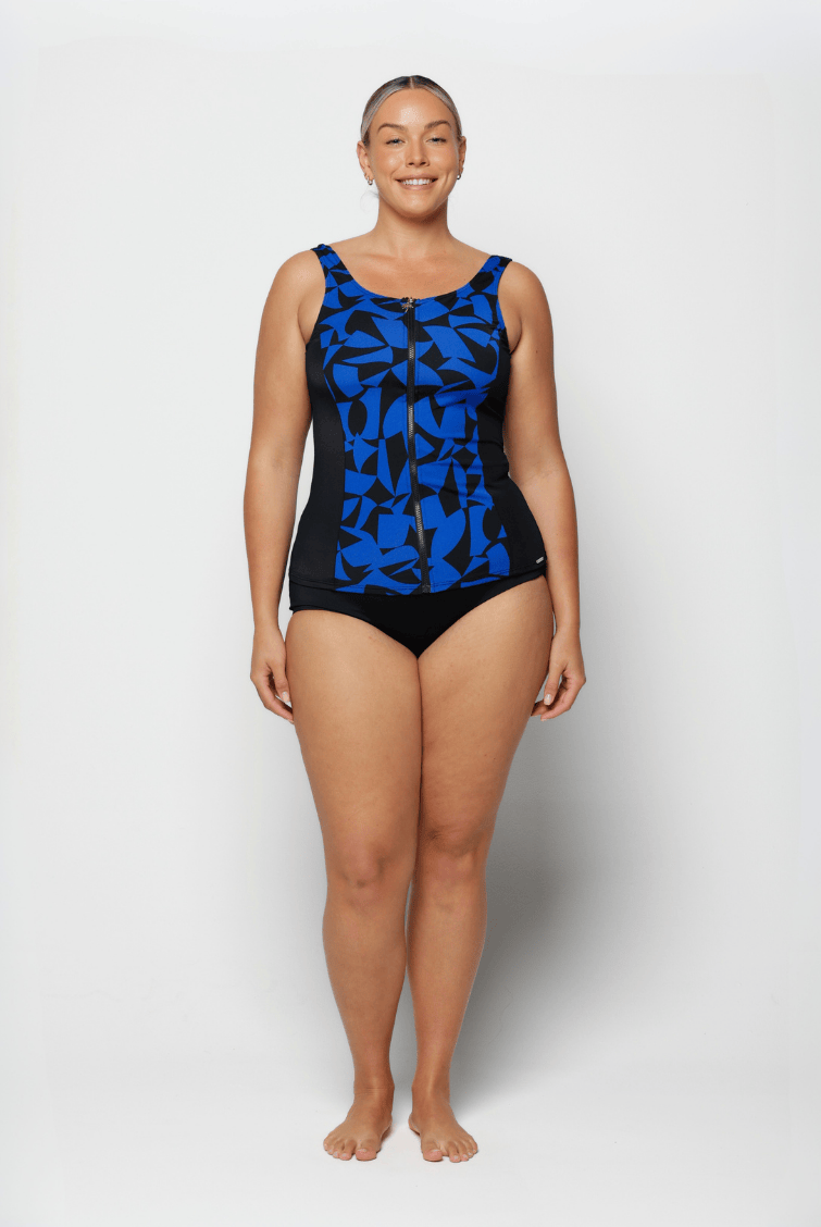 Woman wearing a black and blue patterned swimsuit on a white background