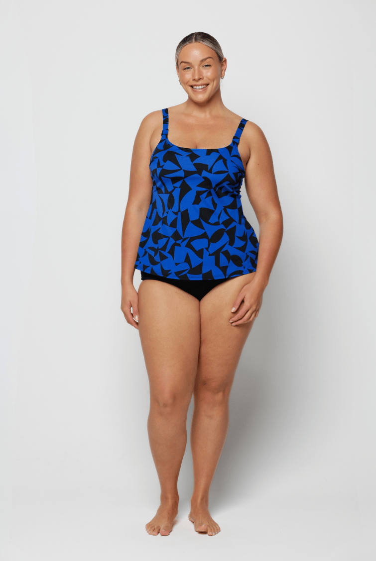 Woman wearing a blue and black patterned swimsuit on a white background