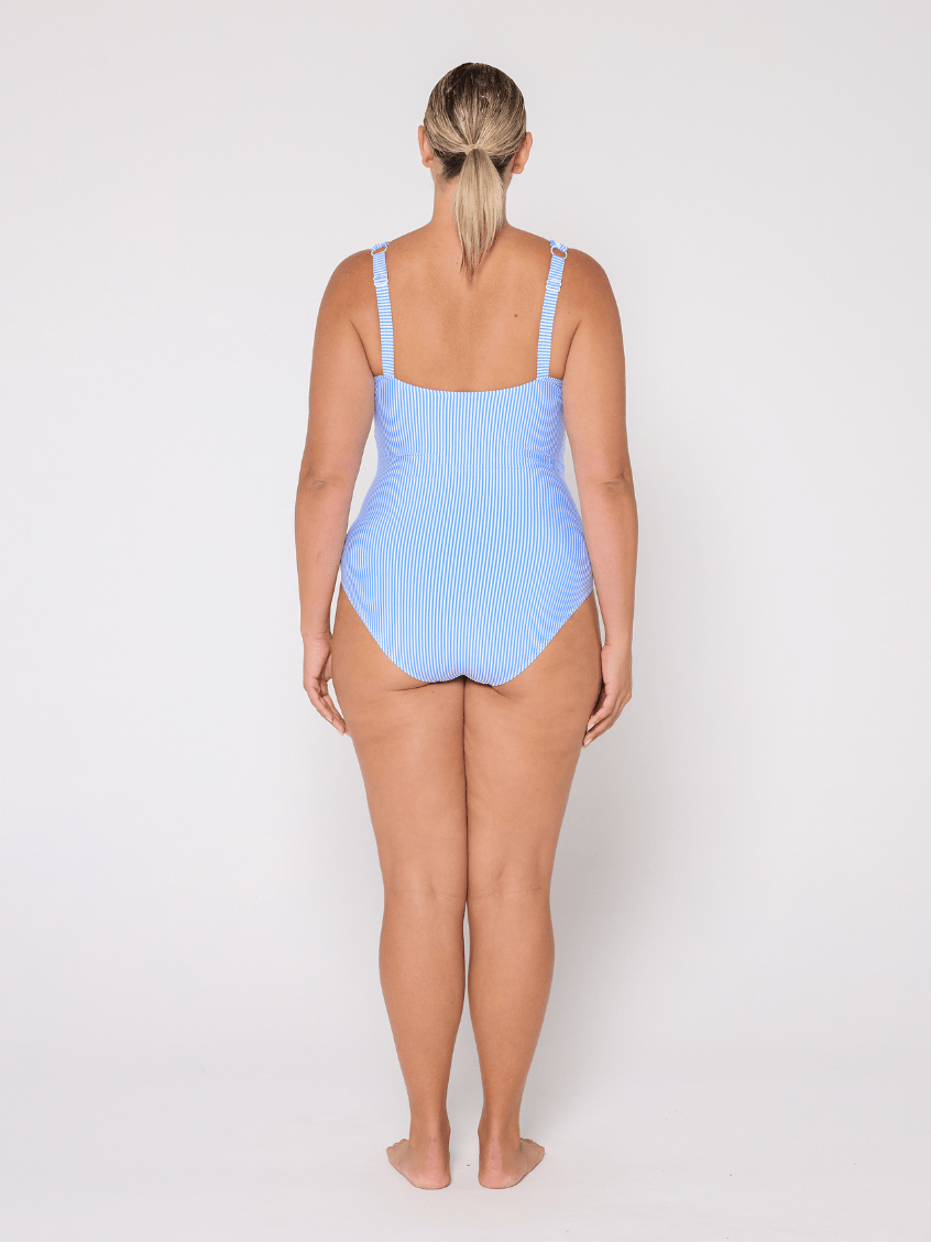 Woman wearing a light blue swimsuit on a white background