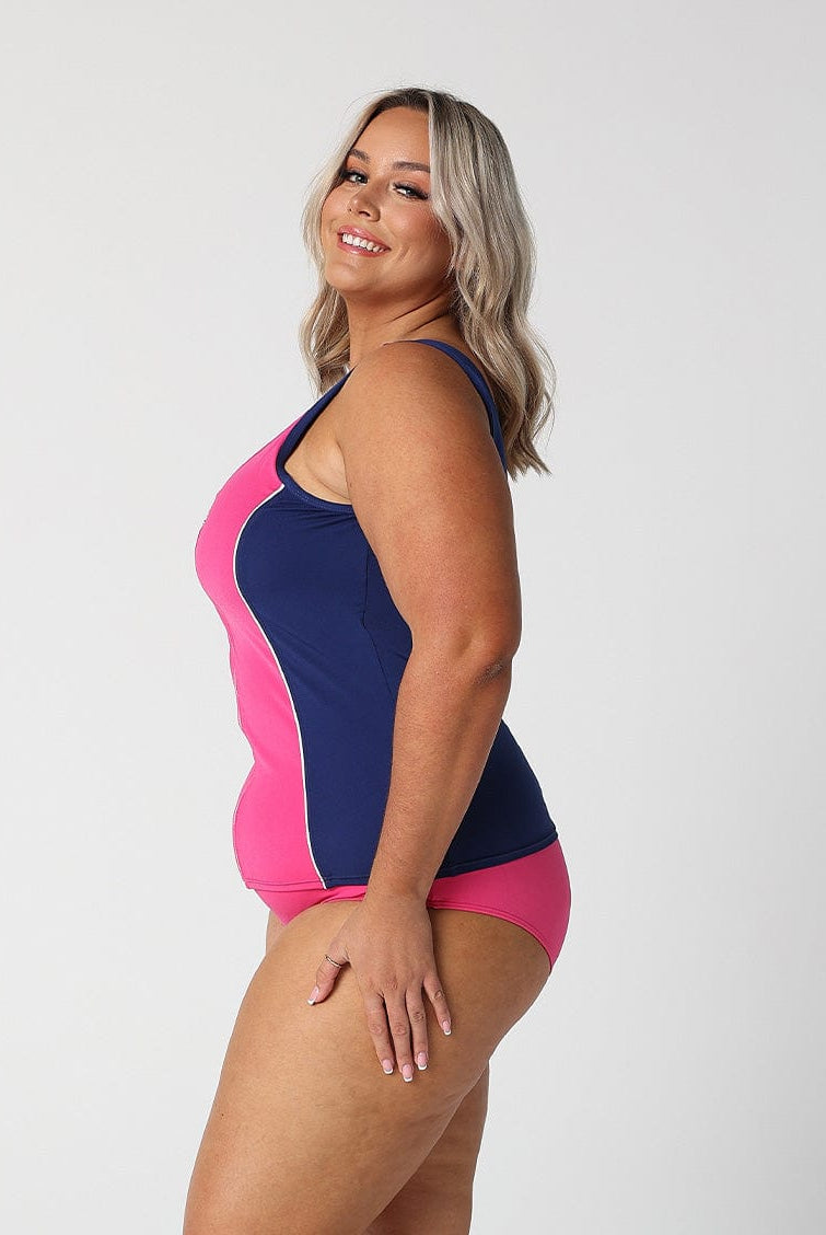 Woman in studio showing side of zip front tankini top in chlorine resistant