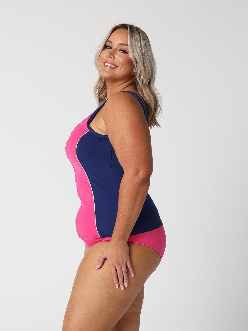Woman in studio showing side of zip front tankini top in chlorine resistant