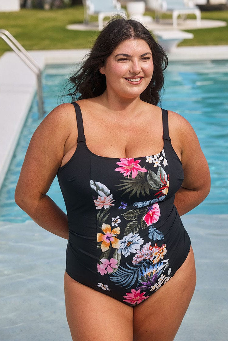 Model wears flattering black and floral square neck swimsuit with adjustable straps