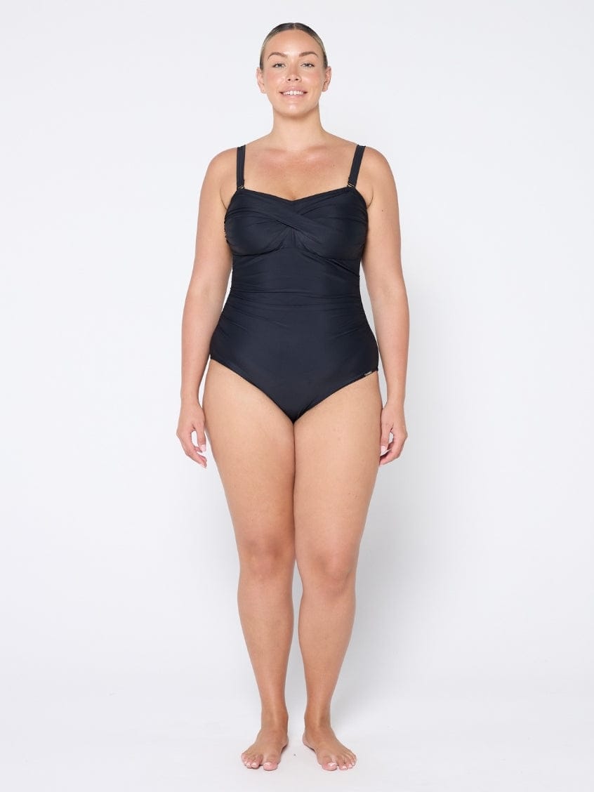 Woman wearing a black swimsuit on a white background