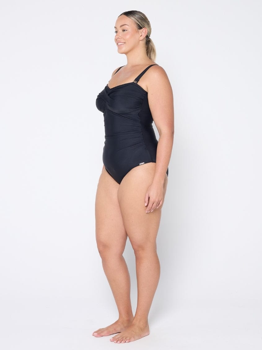 Woman wearing a black swimsuit on a white background