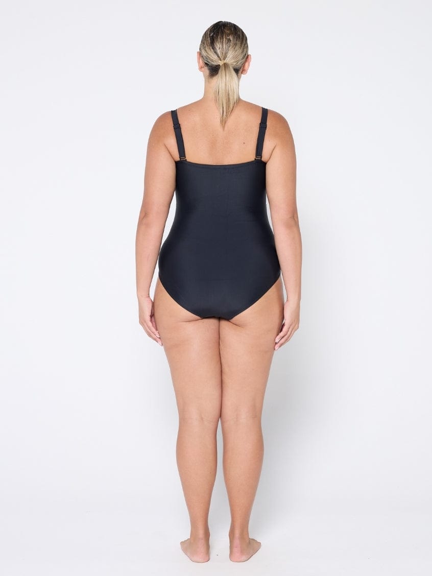 Woman wearing a black swimsuit on a white background