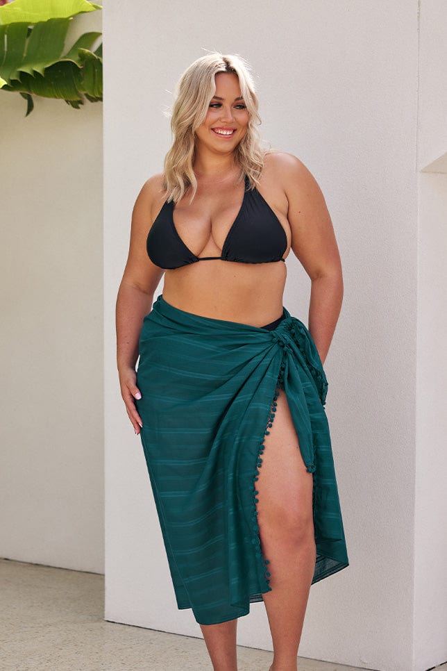 Blonde model wearing long teal sarong