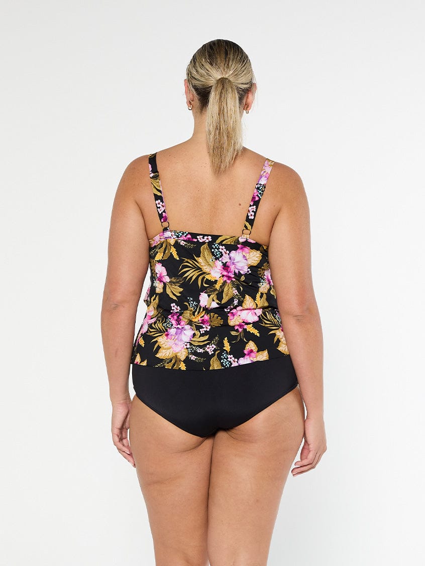 Blonde model shows the back of pink and gold floral chlorine resistant tankini top with adjustable straps