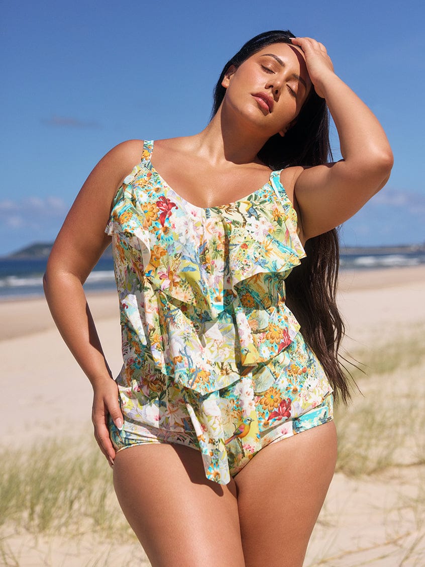 Woman wearing a floral swimsuit on a beach